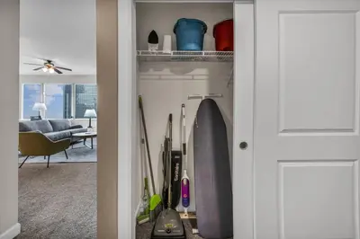 a room with a closet with a surfboard in it at Luxury 21st Floor Penthouse | Great Downtown VIEWS in Cleveland