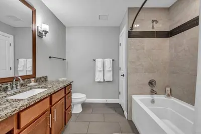 a bathroom with a tub and a toilet and a sink at Luxury 21st Floor Penthouse | Great Downtown VIEWS in Cleveland