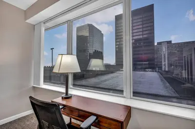 an office with a desk and a window with a view at HUGE Panoramic SkySuite w/ Downtown VIEWS: Gym in Cleveland