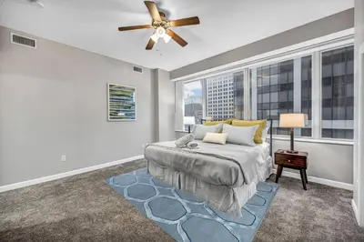 a bedroom with a bed and a large window at HUGE Panoramic SkySuite w/ Downtown VIEWS: Gym in Cleveland