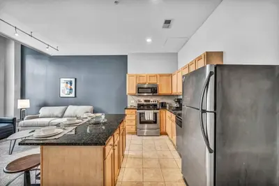 a kitchen with a stainless steel refrigerator at Epic Downtown Pad • Entertain & Unwind in Cleveland