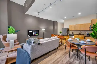 a living room with a couch and a table at The Playhouse Suites 1BD | Parking | Downtown in Cleveland