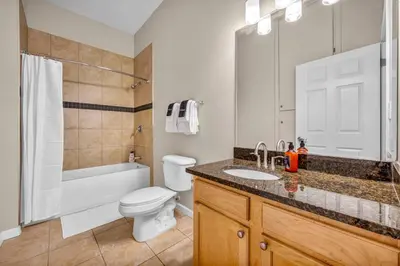 a bathroom with a toilet and a sink and a tub at The Playhouse Suites 1BD | Parking | Downtown in Cleveland