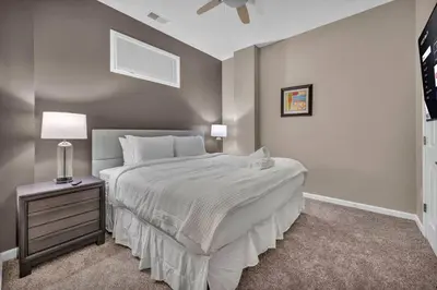 a bedroom with a large white bed with a night stand at The Playhouse Suites 1BD | Parking | Downtown in Cleveland