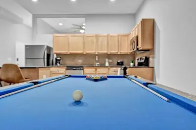 a pool table in the middle of a kitchen at Comfy City Vibe • Theater District Gem in Cleveland