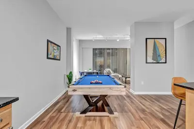 a living room with a pool table in it at Comfy City Vibe • Theater District Gem in Cleveland