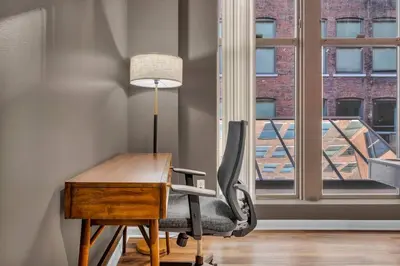 a office with a desk and a chair and a window at Playhouse Square Flat • Pool Table in Cleveland