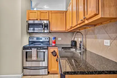 a kitchen with a stove and a microwave at Playhouse Square Flat • Pool Table in Cleveland