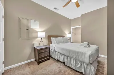 a bedroom with a bed and a night stand with a lamp at Playhouse Square Flat • Pool Table in Cleveland