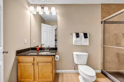 a bathroom with a toilet and a sink and a shower at Playhouse Square Flat • Pool Table in Cleveland