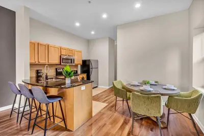 a kitchen and dining room with a table and chairs at Playhouse Square Condo | Parking | Downtown in Cleveland