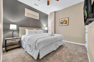 a bedroom with a bed and a flat screen tv at Charming Flat in Amazing Location | Parking in Cleveland