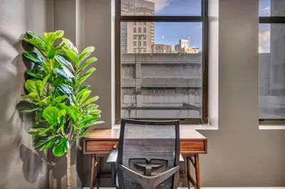 a desk and a chair in a room with a window at Charming Flat in Amazing Location | Parking in Cleveland