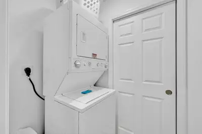 a white bathroom with a sink and a white door at Large 1BD FLAT in the Heart of Downtown in Cleveland