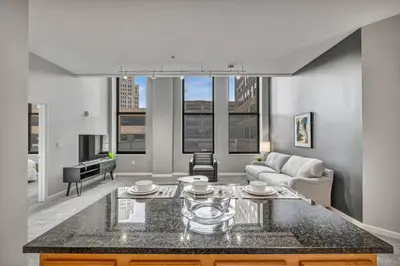a living room with a couch and a table at Large 1BD FLAT in the Heart of Downtown in Cleveland
