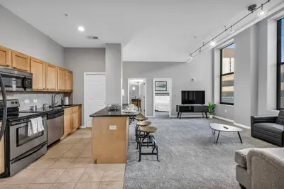 a kitchen and living room with a couch and a table at Large 1BD FLAT in the Heart of Downtown in Cleveland