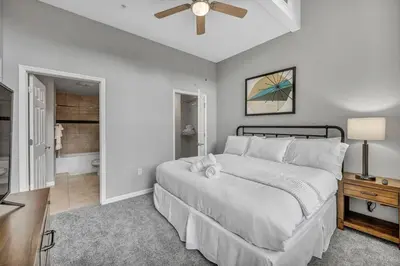 a bedroom with a bed and a ceiling fan at Large 1BD FLAT in the Heart of Downtown in Cleveland