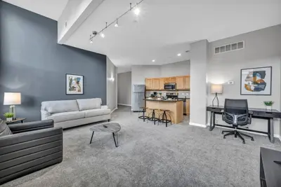 a living room with a couch and a table at Large 1BD FLAT in the Heart of Downtown in Cleveland