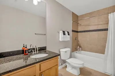 a bathroom with a sink and a toilet and a tub at HUGE Luxe Downtown Flat: Pool Table & Parking in Cleveland