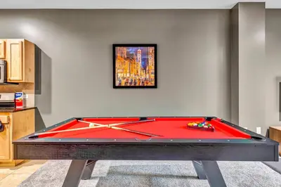 a pool table in a living room with a red pool at HUGE Luxe Downtown Flat: Pool Table & Parking in Cleveland