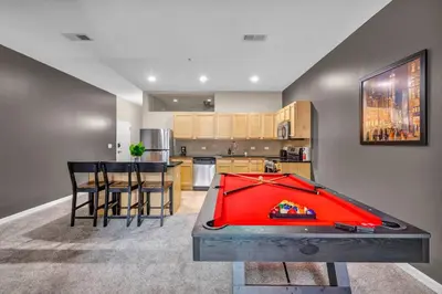 a living room with a pool table and a kitchen at HUGE Luxe Downtown Flat: Pool Table & Parking in Cleveland