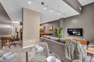 a living room with a couch and a table at HUGE Luxe Downtown Flat: Pool Table & Parking in Cleveland