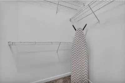 a white room with a tie on a shelf at Comfy City Vibe • Walk to Theaters + Parking $ in Cleveland