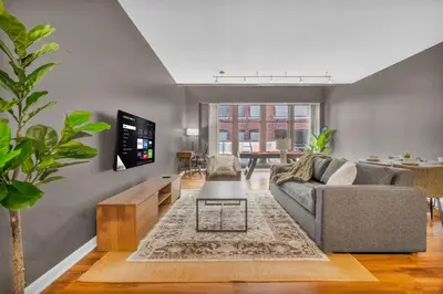 a living room with a couch and a table at Play & Stay Loft Central, Comfy, Parking in Cleveland