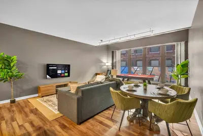 a living room with a couch and a table at Play & Stay Loft Central, Comfy, Parking in Cleveland