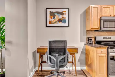 a kitchen with a chair in front of a desk at Playhouse Square Suite | Downtown | Parking in Cleveland