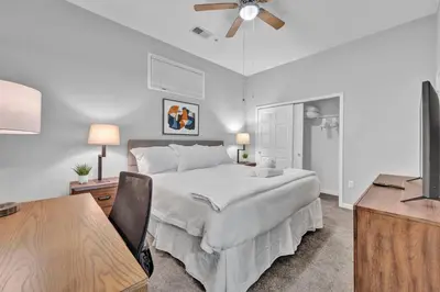 a bedroom with a bed and a desk and a television at Central Downtown Condo | Parking & Pool Table in Cleveland