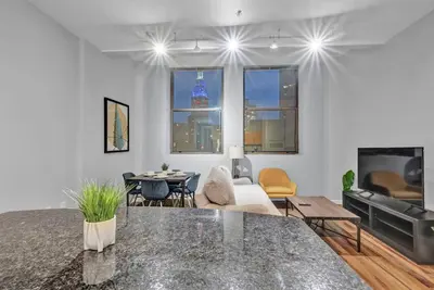 a living room with a table and a couch at Central Downtown Condo | Parking & Pool Table in Cleveland