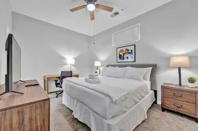 a bedroom with a bed and a flat screen tv at Central Downtown Flat near Attractions and more! in Cleveland