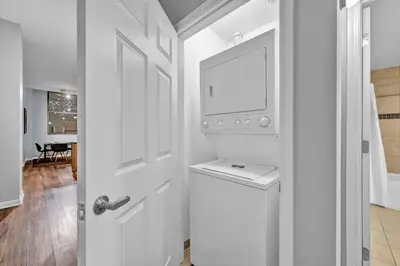 a white door with a tv on a wall at Central Downtown Flat near Attractions and more! in Cleveland