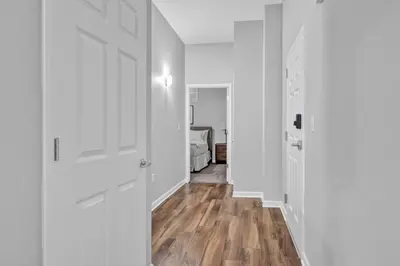 an empty hallway with white walls and wooden floors at Central Downtown Flat near Attractions and more! in Cleveland