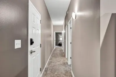 a hallway with a white door and a hallway with a hallway at Luxe Downtown Condo • Pool Table & Parking in Cleveland
