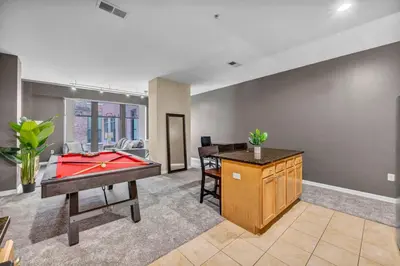 a room with a pool table and a desk at Luxe Downtown Condo • Pool Table & Parking in Cleveland