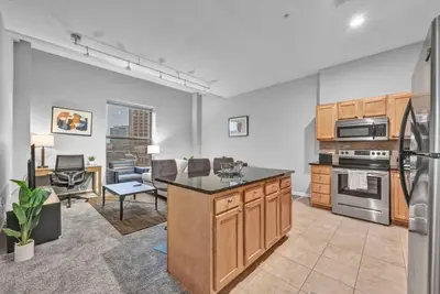 a kitchen with an island in the middle of a room at Theater District Gem • Downtown Hideaway in Cleveland