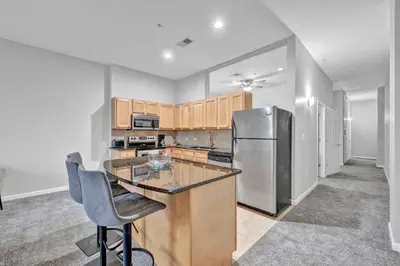 a kitchen with a counter and a refrigerator at Theater District Gem • Downtown Hideaway in Cleveland