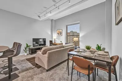 a living room with a couch and a table and chairs at Theater District Gem • Downtown Hideaway in Cleveland