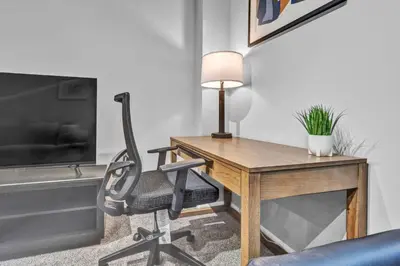 a desk with a chair and a lamp in a room at Theater District Gem • Downtown Hideaway in Cleveland