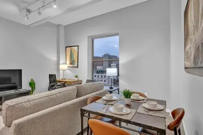 a living room with a couch and a table at Stylish Condo • Walk to Theaters • Parking in Cleveland