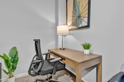 an office with a desk with a chair and a lamp at The Playhouse Suites 2BD | Downtown | Security in Cleveland