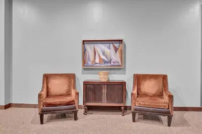 two chairs and a table with a picture on the wall at The Playhouse Suites 2BD | Downtown | Security in Cleveland