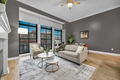 a living room with a couch and a table at Warm and Cozy Downtown Flat: Paid Parking in Cleveland