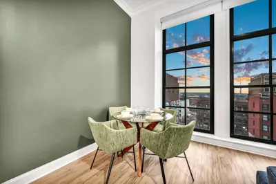a dining room with a table and chairs and a window at Stunning Luxury Downtown Condo in Playhouse Square in Cleveland