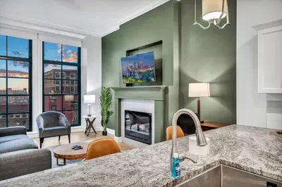 a kitchen and living room with a fireplace at Stunning Luxury Downtown Condo in Playhouse Square in Cleveland