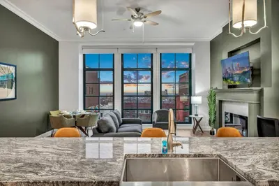 a kitchen with a living room with a fireplace at Stunning Luxury Downtown Condo in Playhouse Square in Cleveland