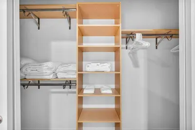 a closet with wooden shelves and folded towels at Stunning Luxury Downtown Condo in Playhouse Square in Cleveland