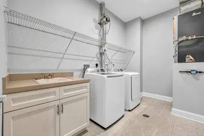 a bathroom with a sink and a washing machine at Ultra Chic Condo in The Heart of Downtown! in Cleveland